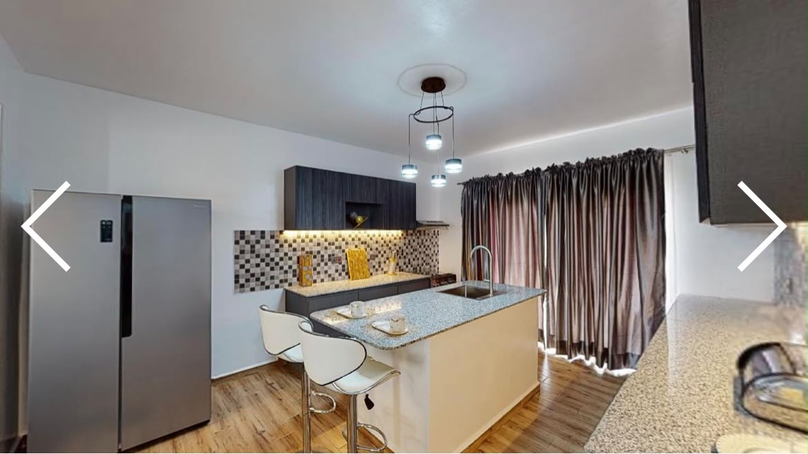 Rendering of an open-plan kitchen and breakfast bar