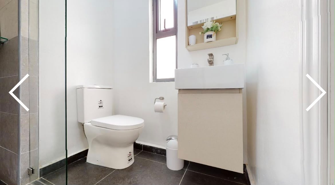 Rendering of a tiled bathroom with walk-in shower